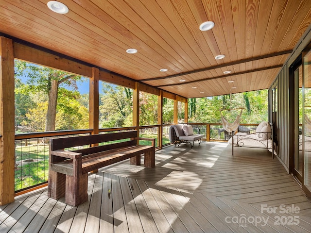 unfurnished sunroom featuring wood ceiling