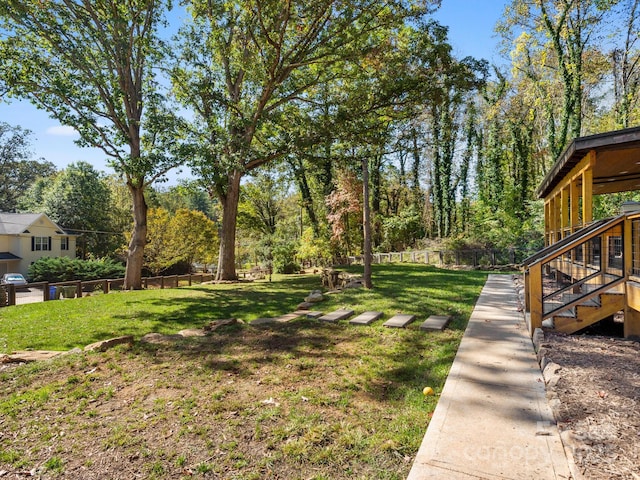 view of yard featuring stairs and fence