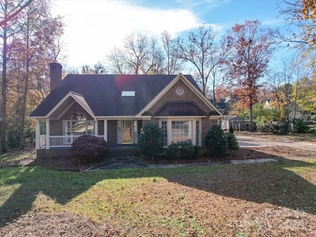 view of front facade with a front yard and covered porch