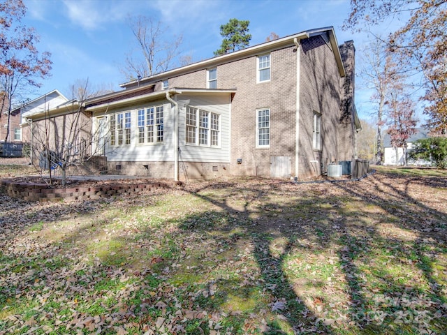 rear view of house with central AC