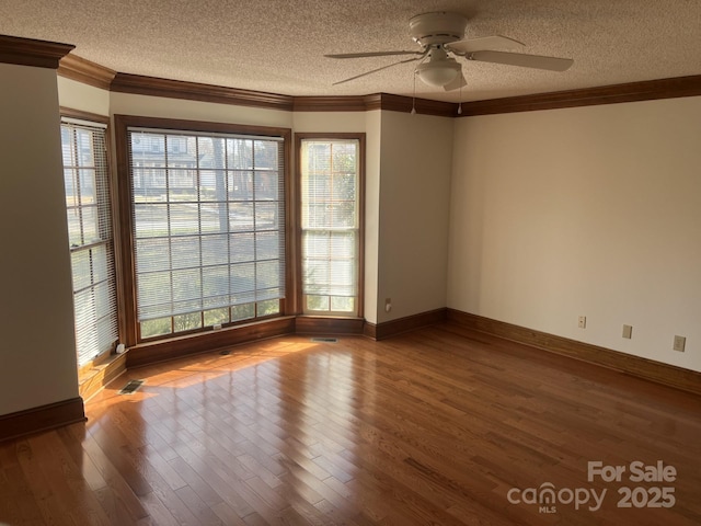 unfurnished room with hardwood / wood-style floors, ornamental molding, a textured ceiling, and ceiling fan