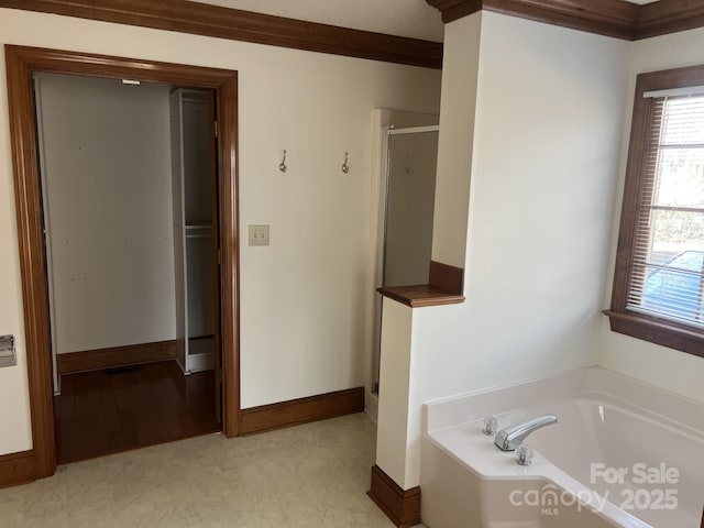 bathroom featuring ornamental molding and shower with separate bathtub