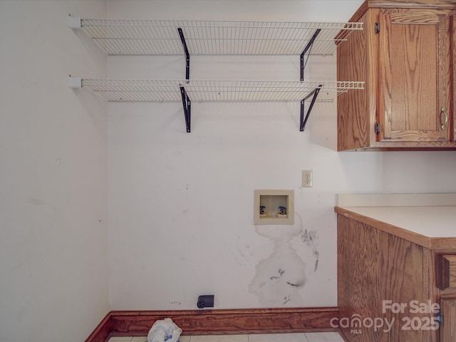 clothes washing area with hookup for a washing machine and cabinets