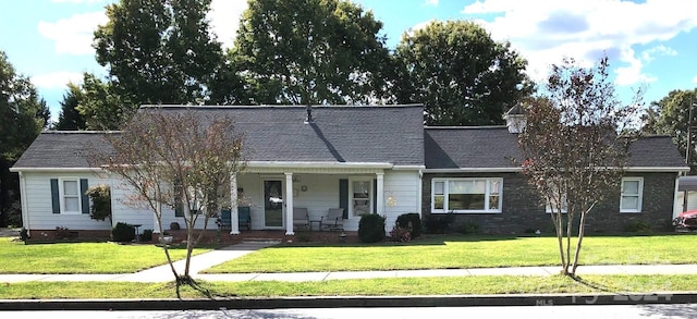 view of front of house with covered porch and a front yard