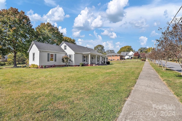 single story home with a front lawn and a porch