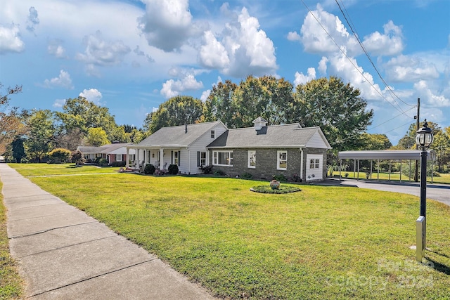 ranch-style house featuring a carport and a front yard