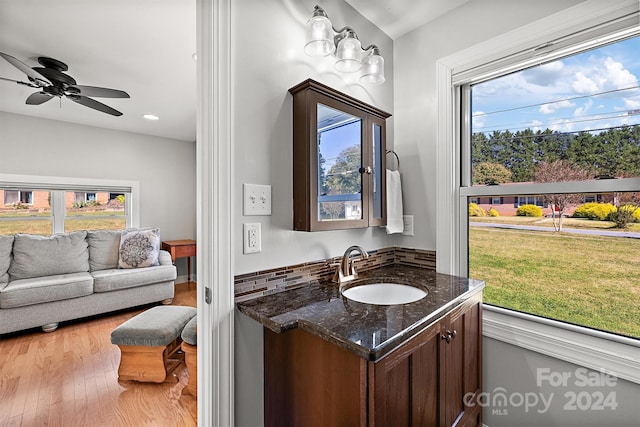 bathroom featuring vanity, a healthy amount of sunlight, hardwood / wood-style flooring, and ceiling fan