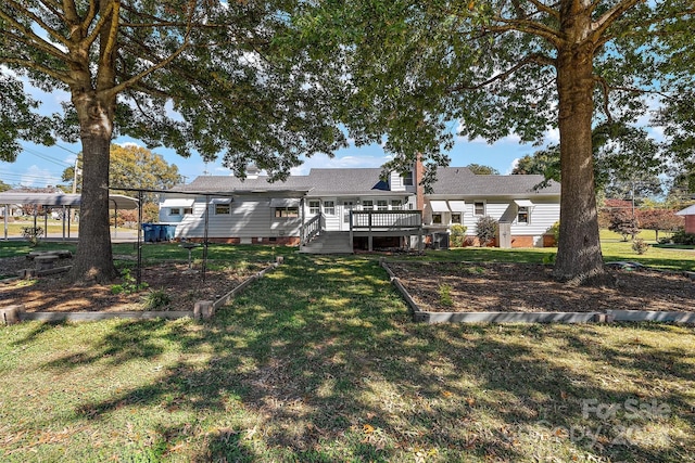 rear view of house featuring a wooden deck and a yard