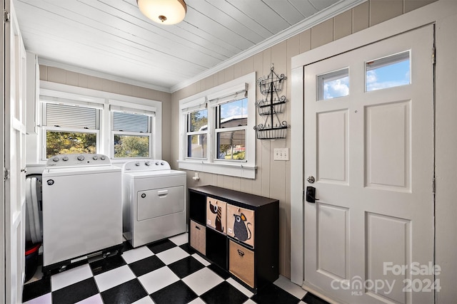 clothes washing area with crown molding and separate washer and dryer