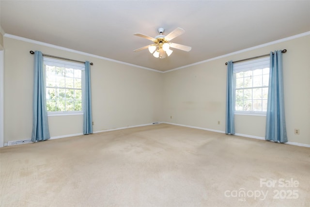 unfurnished room with ornamental molding, light carpet, and plenty of natural light