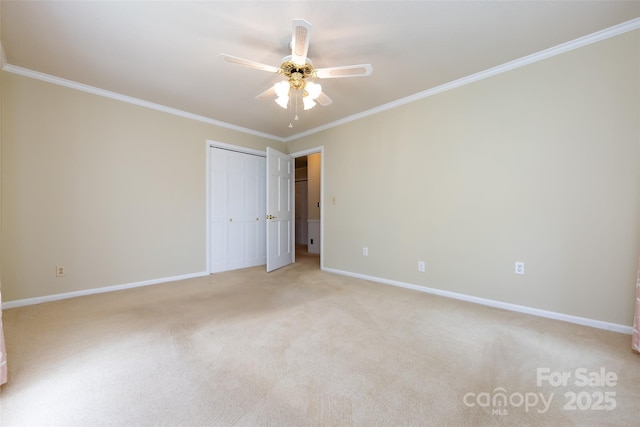 unfurnished bedroom featuring baseboards, light colored carpet, a closet, and ornamental molding