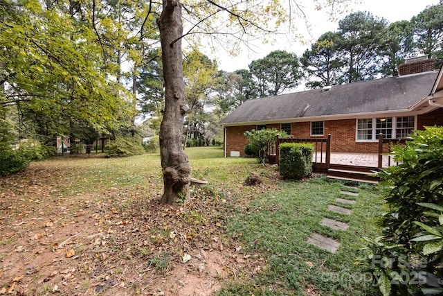 view of yard featuring a wooden deck