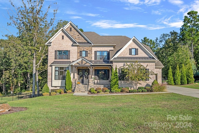 craftsman-style house with a front lawn and covered porch