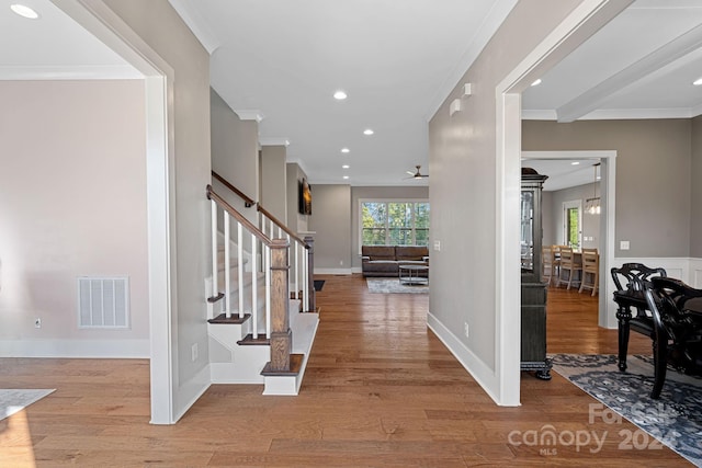 entryway with crown molding, light hardwood / wood-style flooring, and ceiling fan