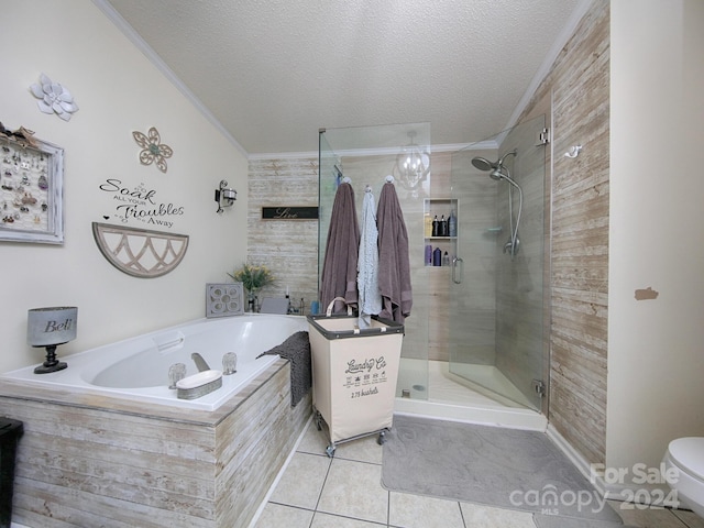 bathroom with tile patterned flooring, toilet, plus walk in shower, crown molding, and a textured ceiling