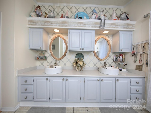 bathroom featuring tile patterned floors, crown molding, and vanity