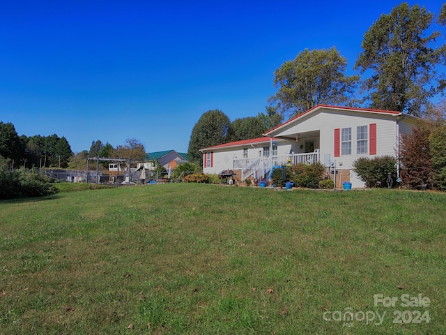 exterior space with a front lawn and a porch