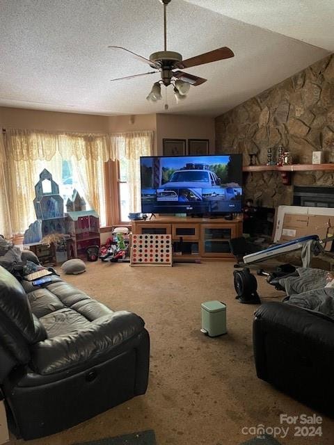 carpeted living room with ceiling fan, vaulted ceiling, and a textured ceiling