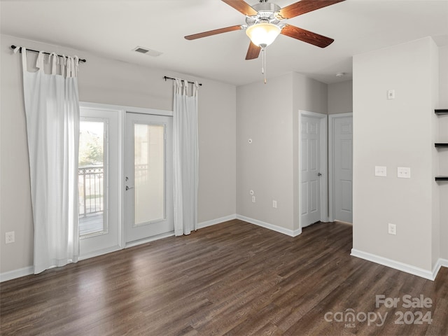 spare room with ceiling fan and dark hardwood / wood-style flooring