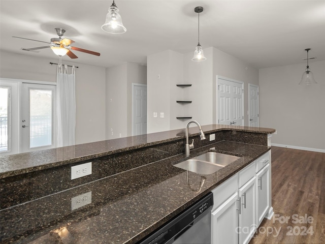 kitchen featuring pendant lighting, dark stone counters, dark hardwood / wood-style floors, and sink