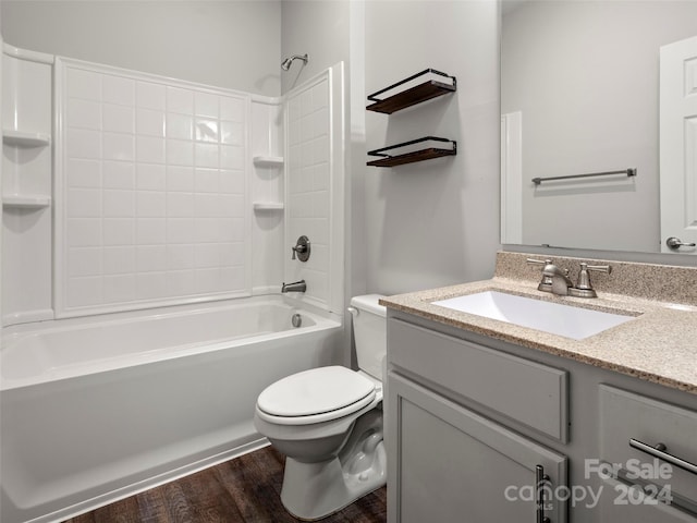 full bathroom with shower / tub combination, hardwood / wood-style floors, vanity, and toilet