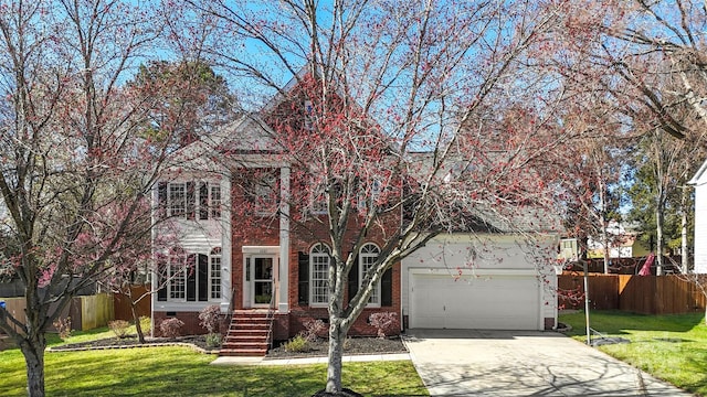 view of front of property featuring concrete driveway, a front lawn, fence, and brick siding