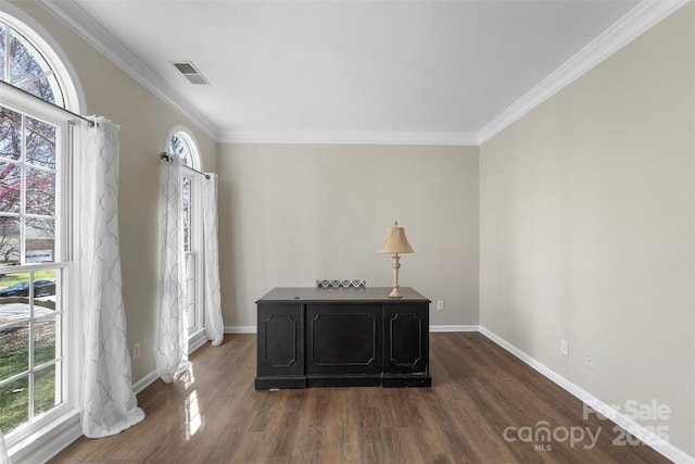 office with visible vents, baseboards, dark wood-type flooring, and ornamental molding