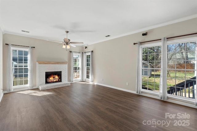 unfurnished living room with dark wood-style floors, visible vents, baseboards, and crown molding