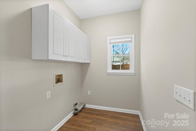 laundry room featuring cabinet space, baseboards, dark wood finished floors, and washer hookup