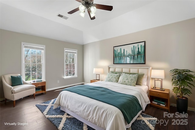 bedroom featuring baseboards, visible vents, a ceiling fan, lofted ceiling, and wood finished floors