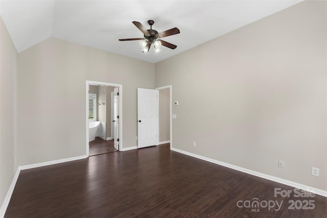 unfurnished room with vaulted ceiling, ceiling fan, dark wood-type flooring, and baseboards