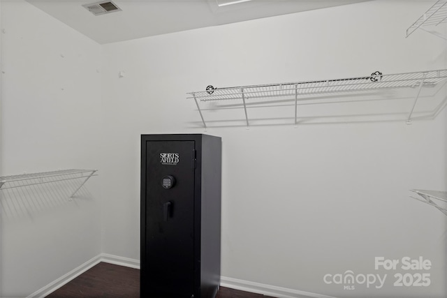 walk in closet featuring dark wood-type flooring and visible vents