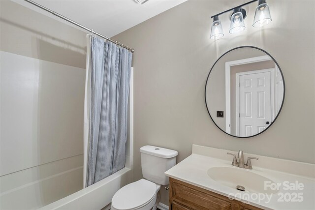 bathroom featuring toilet, shower / tub combo with curtain, and vanity