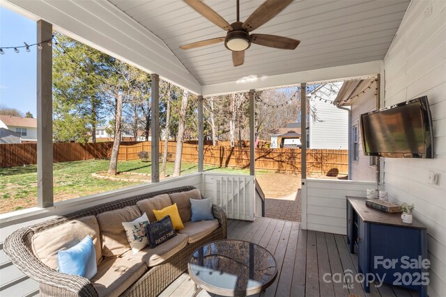 sunroom / solarium with ceiling fan, wood ceiling, and vaulted ceiling