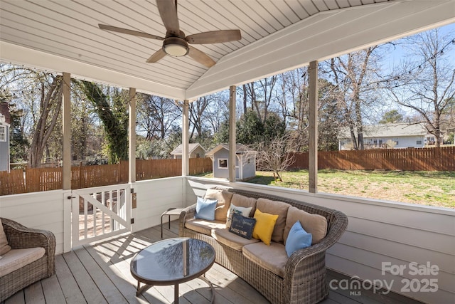 sunroom / solarium with a ceiling fan, lofted ceiling, and wooden ceiling