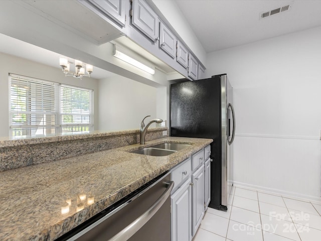 kitchen featuring gray cabinetry, a notable chandelier, sink, and light tile patterned floors