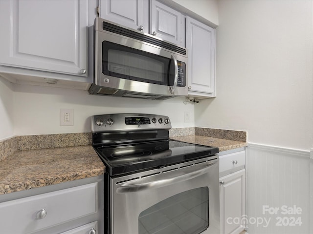 kitchen featuring appliances with stainless steel finishes and white cabinetry