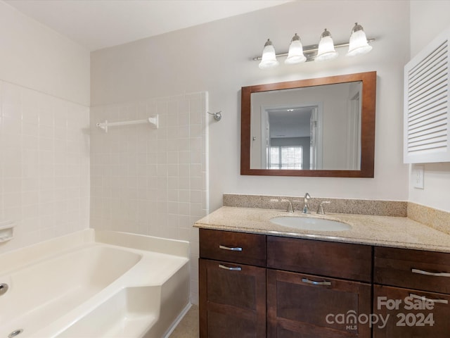 bathroom featuring vanity and a bath