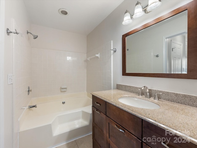 bathroom featuring vanity, tiled shower / bath combo, and tile patterned floors