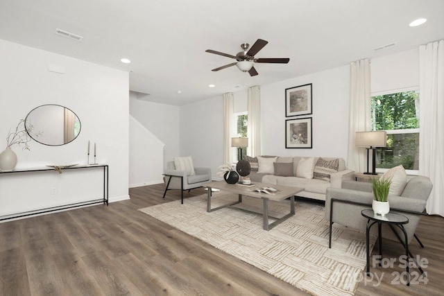 living room featuring wood-type flooring and ceiling fan