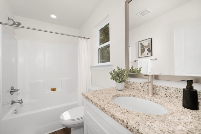 full bathroom with vanity, shower / tub combo, and toilet