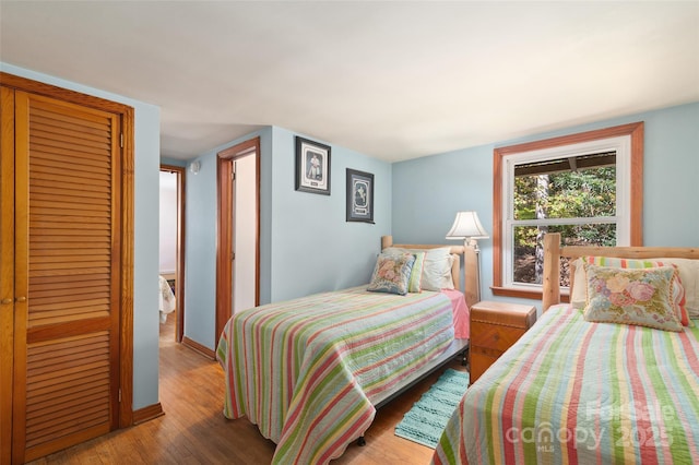 bedroom featuring wood-type flooring and a closet