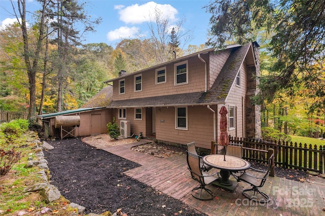 back of house with ac unit and a deck