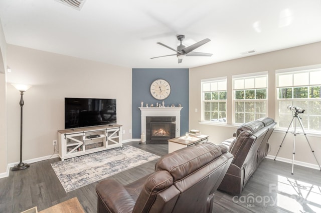 living room with ceiling fan and dark hardwood / wood-style flooring