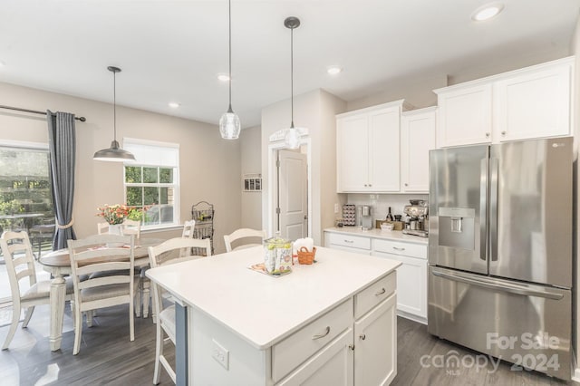 kitchen with white cabinets, stainless steel refrigerator with ice dispenser, pendant lighting, and a center island