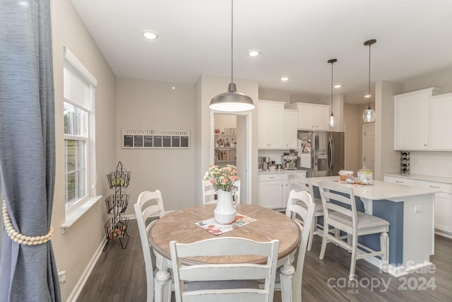 dining space with dark hardwood / wood-style floors and a wealth of natural light