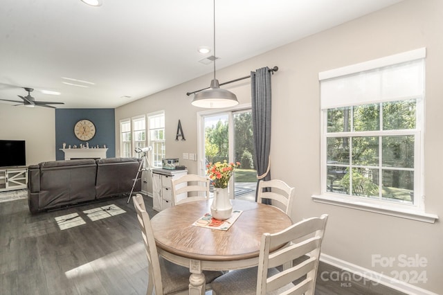 dining area with dark wood-type flooring and ceiling fan