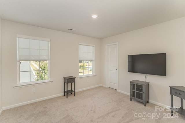 unfurnished living room with light carpet