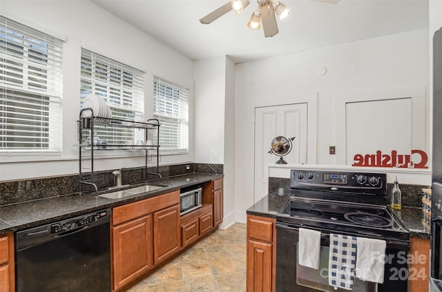 kitchen with dark stone countertops, ceiling fan, black appliances, and sink