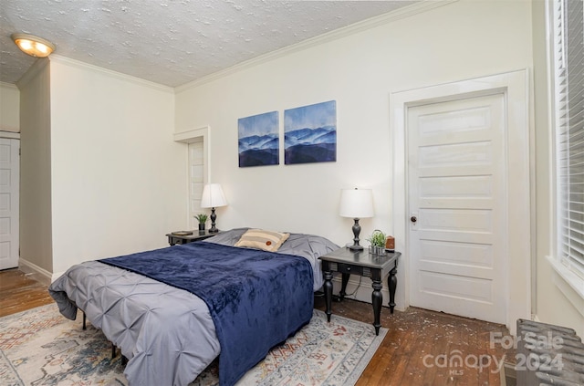 bedroom featuring ornamental molding, a textured ceiling, and dark hardwood / wood-style flooring